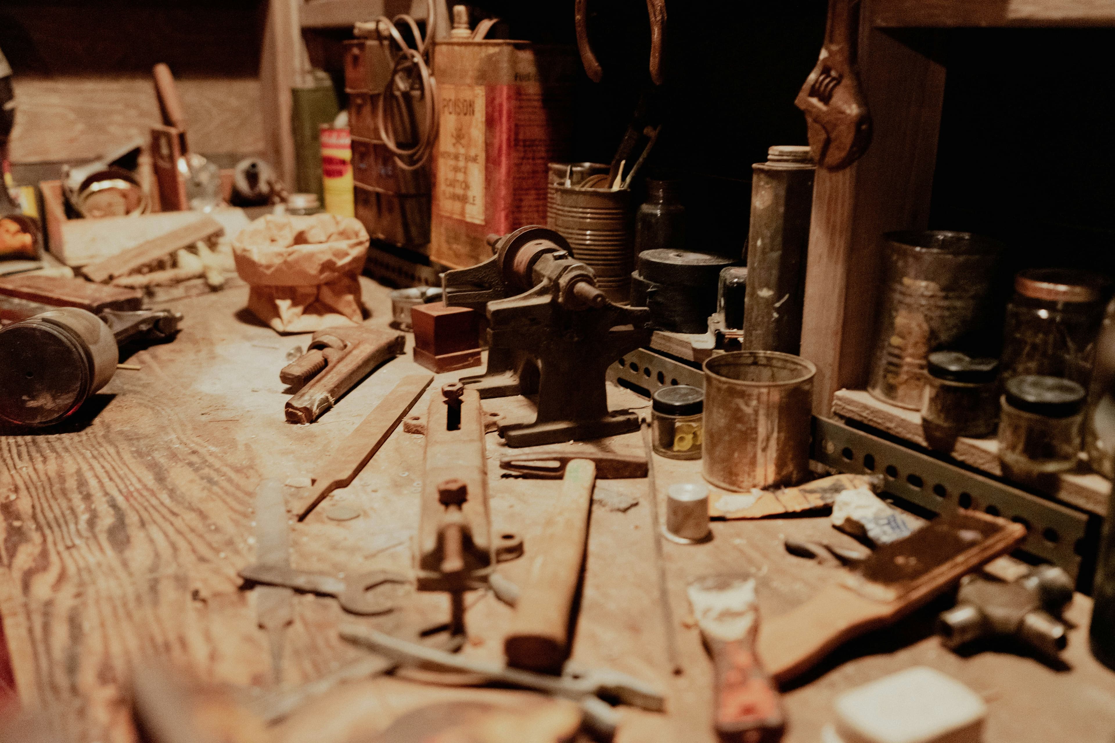 A dusty workbench with old hand tools and a bench vise, untouched for years